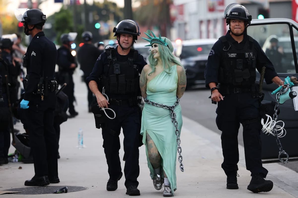 Police arrest a protestor dressed as the Statue of Liberty, in downtown Los Angeles after the “No Kings” rally Saturday, March 28, 2026. (AP Photo/Jill Connelly)