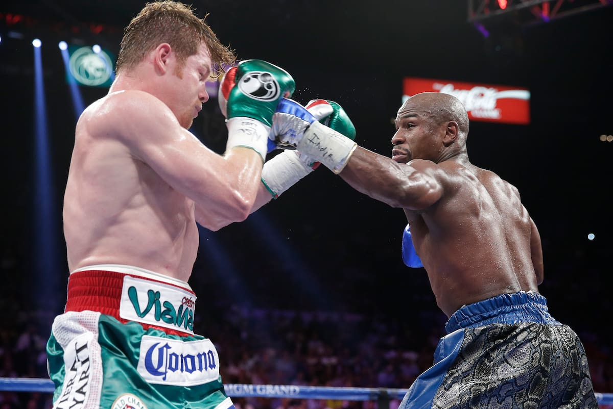 Floyd Mayweather Jr. lands a jab against Canelo Alvarez in the fifth round during a 152-pound title fight, Saturday, Sept. 14, 2013, in Las Vegas. (AP Photo/Eric Jamison)