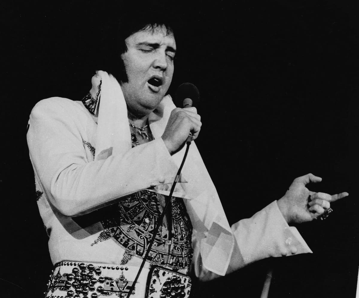 ** FILE ** Elvis Presley is shown performing in Providence, R.I., in this May 23, 1977, file photo. In observance of the 25th anniversary of Presley's death, the Cumberland County Civic Center in Portland, Maine, will present a two-hour musical tribute, ``The Concert That Never Happened,'' on Aug. 17, 2002, featuring Elvis impersonator Jack Smink. Presley, who died Aug. 16, 1977, was scheduled to perform at the Civic Center Aug. 17 and Aug. 18, 1977. (AP Photo/File)