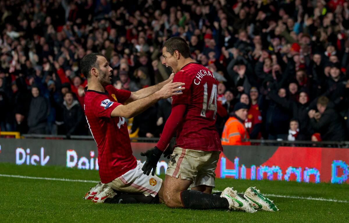 Manchester United's Javier Hernandez, right, celebrates with teammate Ryan Giggs after scoring against Newcastle United during their English Premier League soccer match at Old Trafford Stadium, Manchester, England, Wednesday Dec. 26, 2012. (AP Photo/Jon Super)