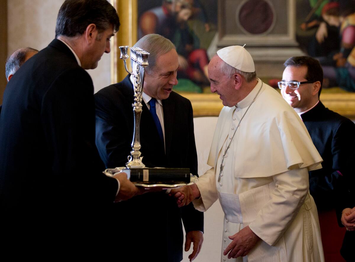 Israeli Prime Minister Benjamin Netanyahu, left, presents Pope Francis with a Menorah during their meeting at the Vatican, Monday, Dec. 2, 2013. Netanyahu is on a visit to Italy, which include a meeting with Pope Francis at the Vatican. (AP Photo/Alessandra Tarantino, Pool)