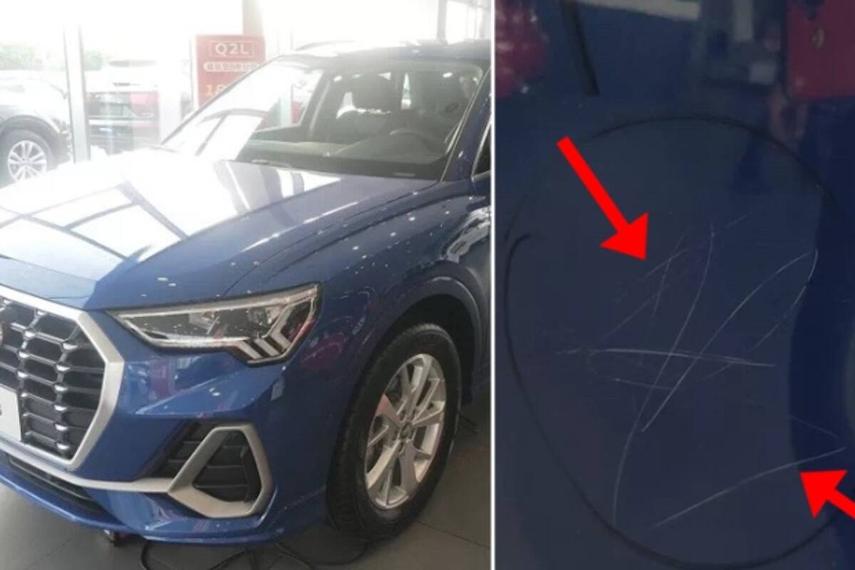 Niña raya con una piedra diez Audi en una concesionaria