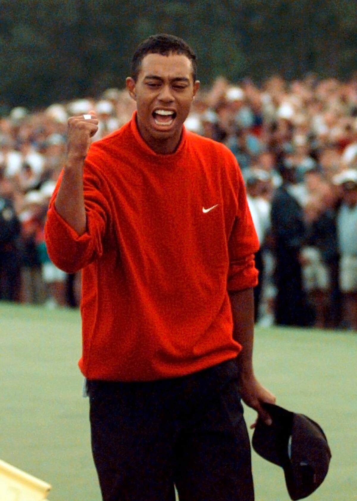 En esta fotografía de archivo del 17 de abril de 1997, Tiger Woods celebra cuando abandona el green 18 después de ganar el torneo Masters de golf en el Augusta National Golf Club en Augusta, Georgia. En un comunicado el martes 16 de marzo de 2010, Woods dijo que jugará en Augusta National después de una pausa de cuatro meses debido a un escándalo sexual. El Masters comienza el 8 de abril. (Foto AP/Dave Martin, Archivo)