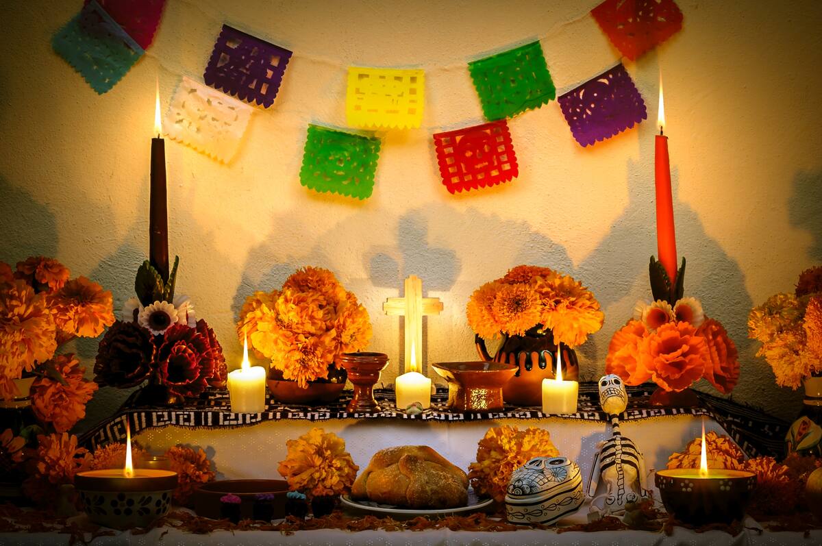 Traditional mexican Day of the dead altar with cempasuchil flowers and candles.