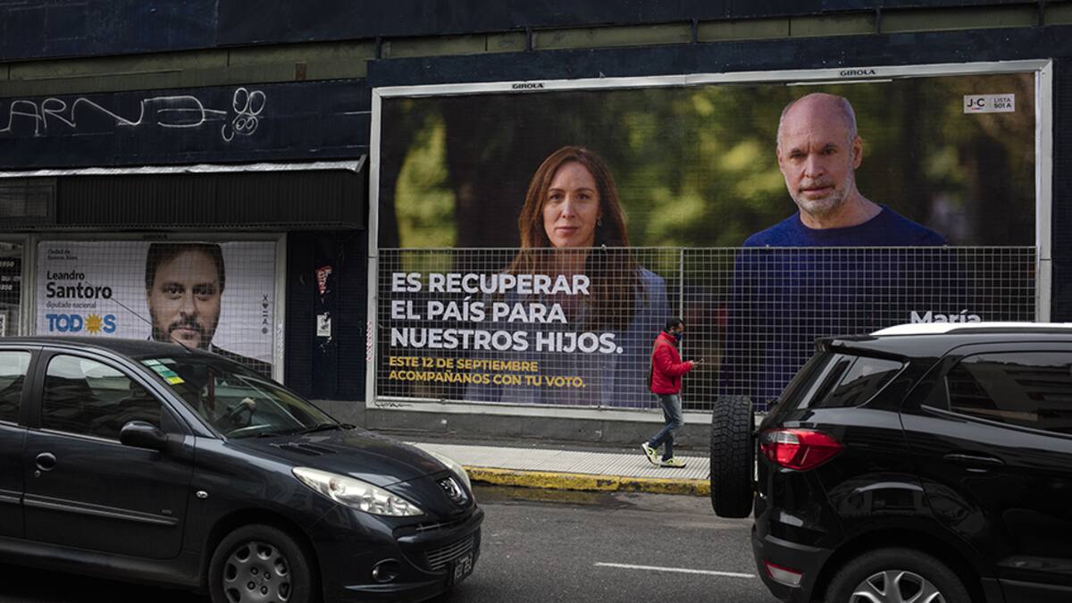 BUENOS AIRES, SEPTEMBER 06: A man walks past a campaign poster of Leandro Santoro candidate of Frente de Todos party and the campaign poster of Maria Eugenia Vidal candidate for National Deputy and Horacio Rodriguez Larreta (R), Mayor of Buenos Aires City of Juntos por el Cambio party on September 06, 2021 in Buenos Aires, Argentina. Argentinians will vote on Sunday September 12 for the mid-term primary elections amid COVID-19 pandemic. (Photo by Ricardo Ceppi/Getty Images)