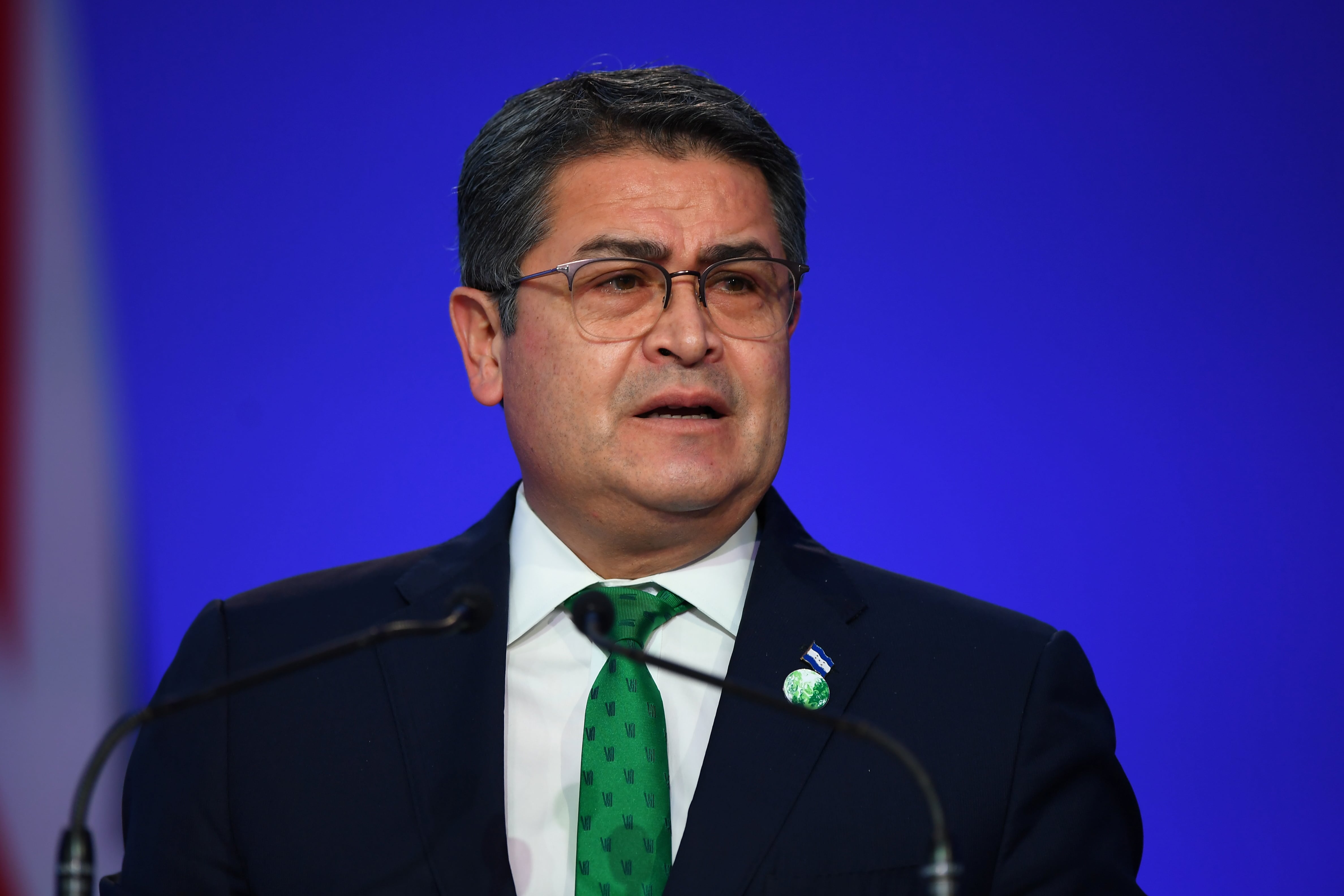 FOTO DE ARCHIVO: El presidente de Honduras, Juan Orlando Hernández, presenta su declaración nacional como parte de la Cumbre de Líderes Mundiales en la Conferencia de las Naciones Unidas sobre el Cambio Climático (COP26) en Glasgow, Escocia, Gran Bretaña 1 de noviembre de 2021. Andy Buchanan/Pool vía REUTERS/File Photo