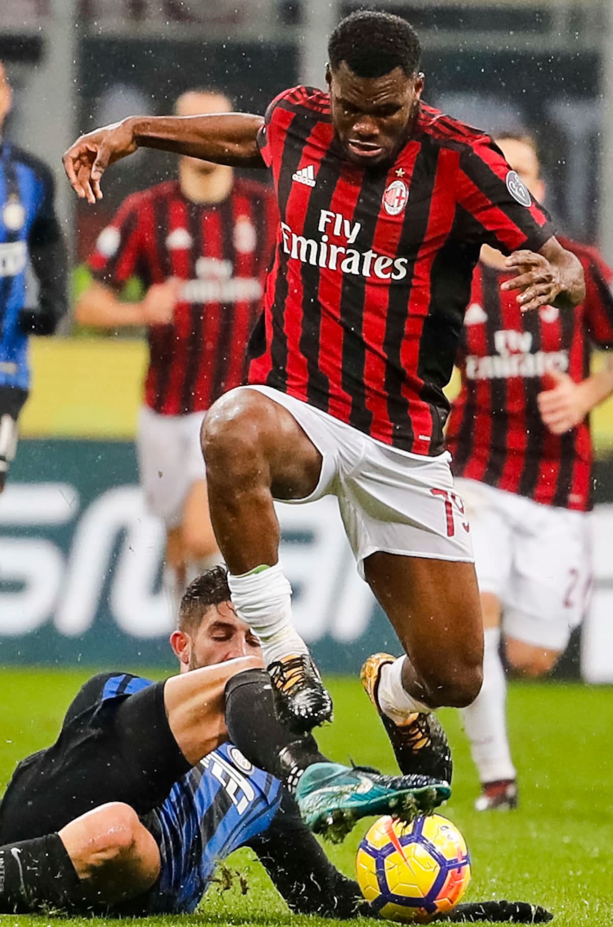 AC Milan's Franck Kessie, right, is tackled by Inter Milan's Alessio Romagnoli during an Italian Cup quarter-final soccer match between Milan and Inter Milan at the San Siro stadium in Milan, Italy, Wednesday, Dec. 27, 2017. (AP Photo/Antonio Calanni)
