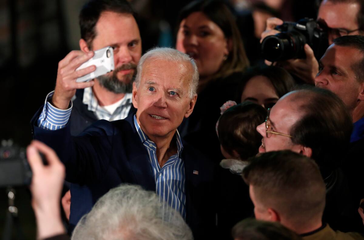 Former Vice President and Democratic presidential candidate Joe Biden poses for photos with audience members during a rally, Wednesday, May 1, 2019, in Des Moines, Iowa. (AP Photo/Charlie Neibergall)