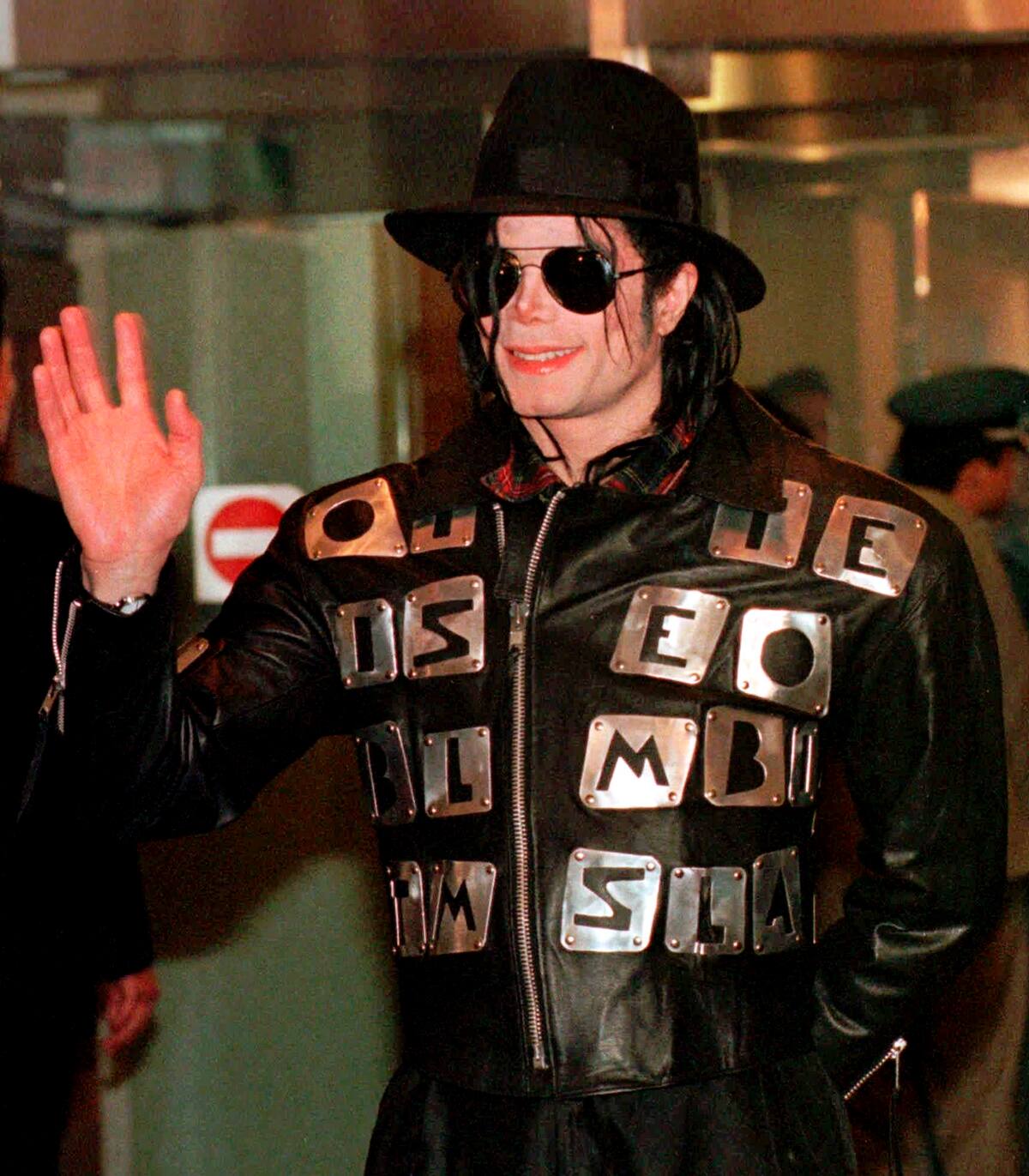 FILE - In this Feb. 22, 1998 file photo, U.S. pop star Michael Jackson waves after arriving at the Kimpo Airport in Seoul to attend the inauguration ceremony for President-elect Kim Dae-jung and also discuss plans for a benefit concert to aid starving North Korean children. David Fournier, a nurse anesthetist who treated Jackson between 1993 and 2003 told a Los Angeles jury on Thursday July 25, 2013, in a civil case against AEG Live filed by Jacksons mother, that the singer had a high tolerance for anesthesia and was not always forthcoming with his medical history. Fournier said he stopped working on Jackson after the singer seemed unfit to undergo cosmetic surgery in 2003. (AP Photo/Ahn Young-joon, File)