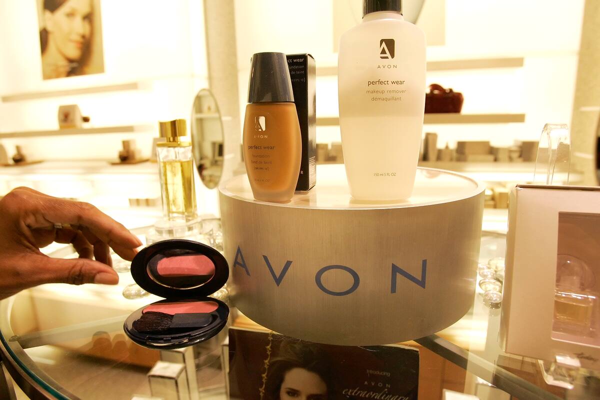 FILE - In this file photo made Nov. 15, 2005, a saleswoman, who did not give her name, places items for a picture on display in an Avon store in New York. Struggling Avon Products Inc. is rejecting a buyout offer worth about $10 billion from beauty company Coty Inc., as Coty went public with the bid Monday, April 2, 2012. (AP Photo/Gregory Bull, File)