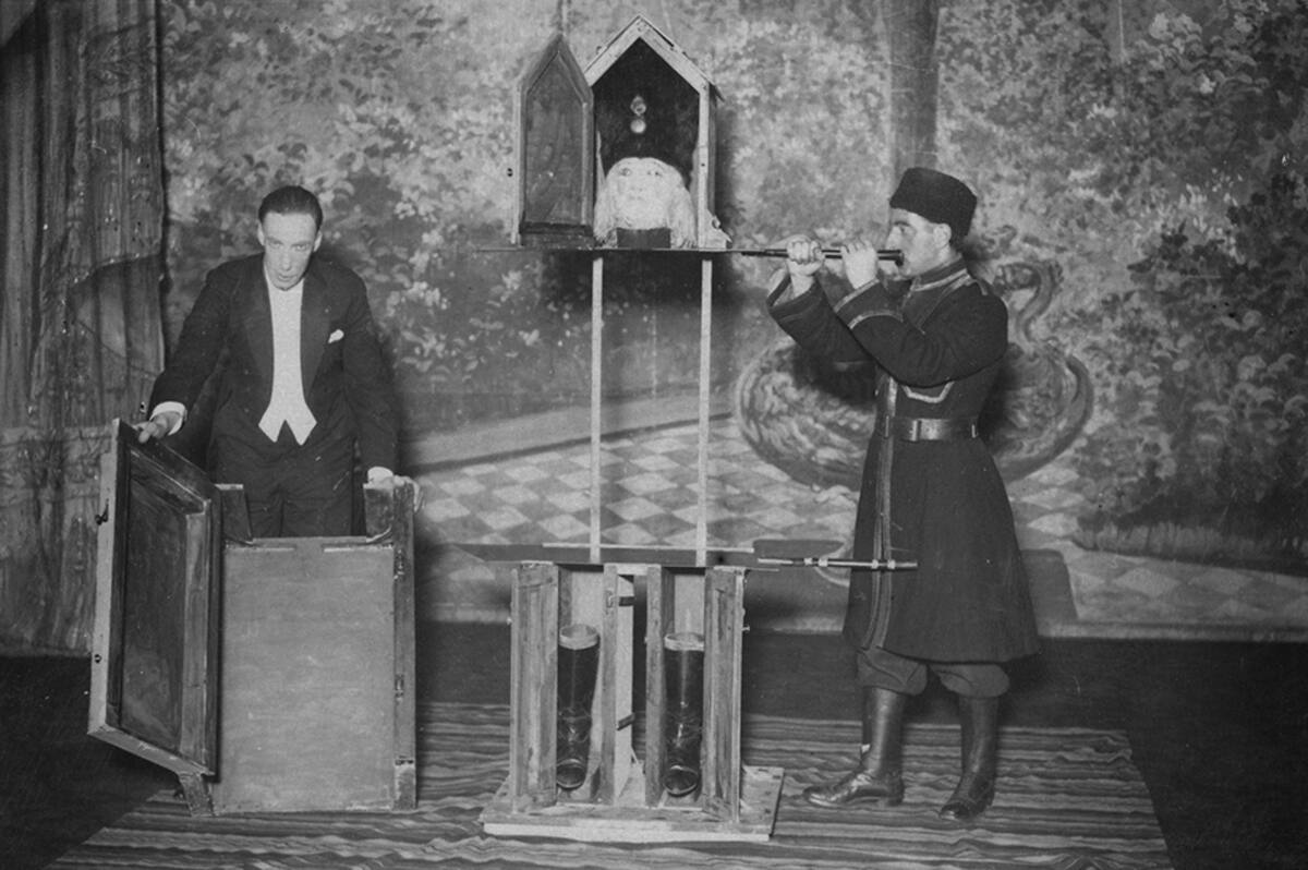 English stage magician P. T. Selbit (1881 - 1938, left) performs his latest mystery at Maskelyne's in London, UK, 26th February 1924. A soldier is placed in a sentry box and divided into three portions. Selbit is credited with first performing the illusion of sawing a woman in half, in 1921. (Photo by A. R. Coster/Topical Press Agency/Hulton Archive/Getty Images)