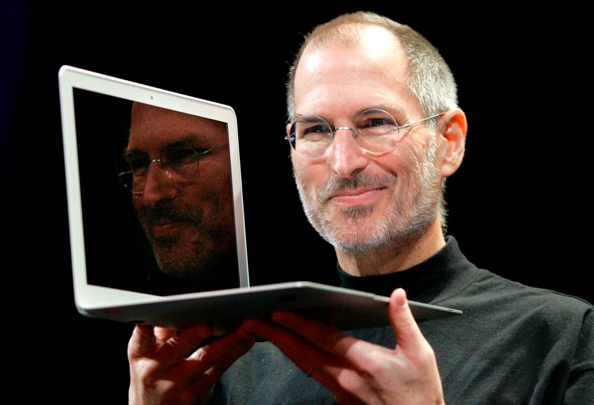 FILE - In this Jan. 15, 2008, file photo, Apple CEO Steve Jobs holds up the new MacBook Air after giving the keynote address at the Apple MacWorld Conference in San Francisco. Apple on Wednesday, Oct. 5, 2011 said Jobs has died. He was 56. (AP Photo/Jeff Chiu, File)