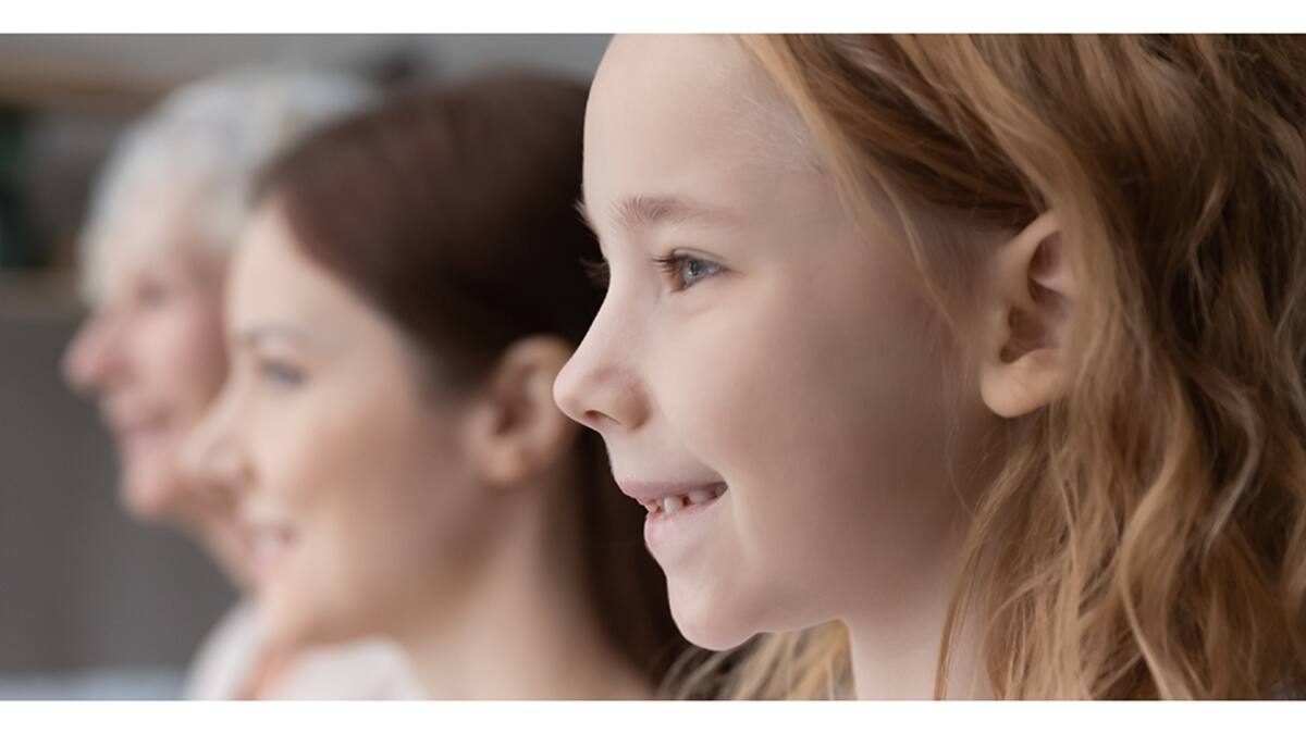 Banner horizontal panoramic view of smiling three generations of women look in distance dream of bright future, profile of happy girl with mom and grandmother visualize together, family unity concept