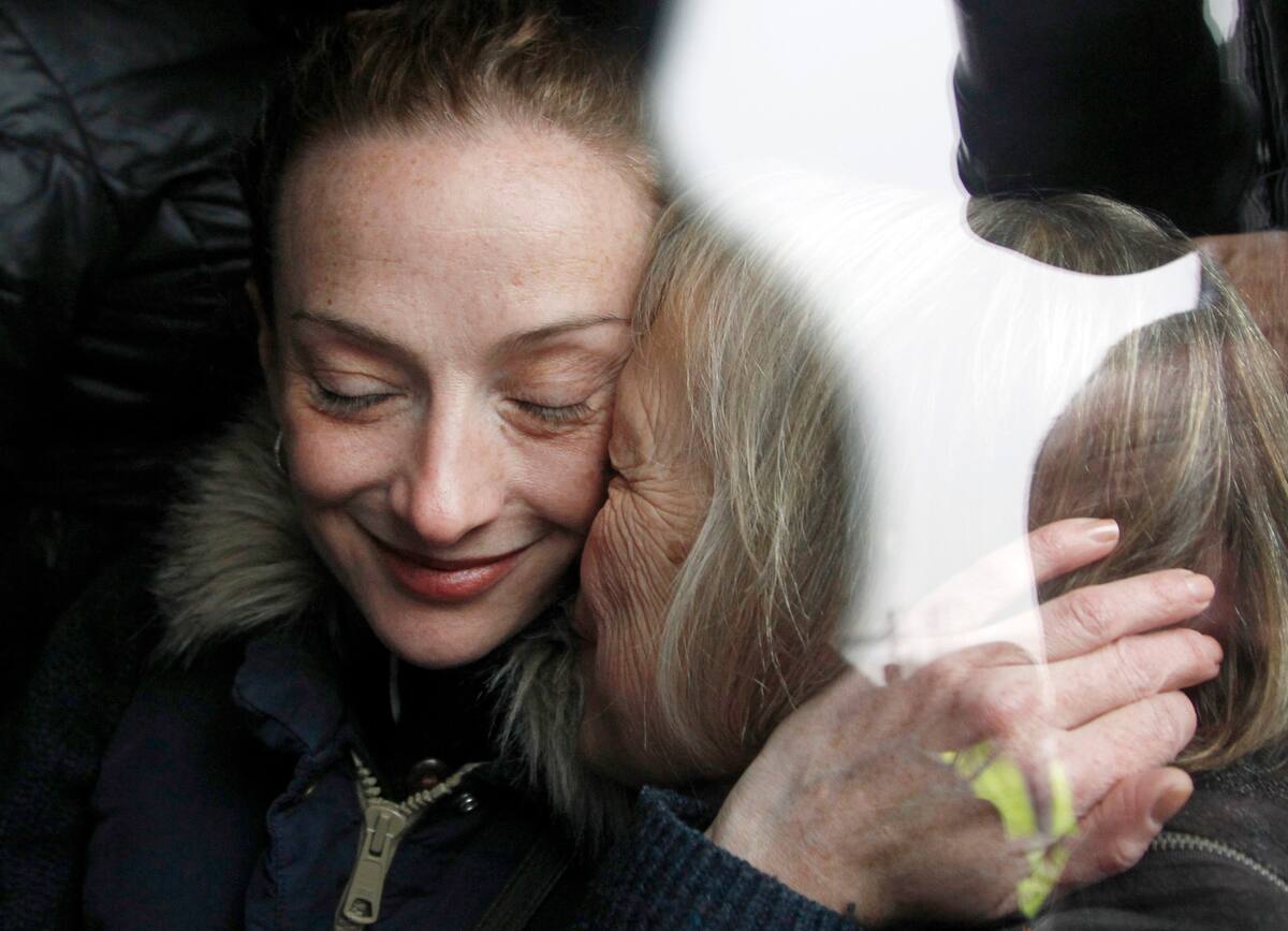 Frenchwoman Florence Cassez, left, is kissed by her mother Charlotte after landing at Roissy airport, north of Paris, Thursday, Jan.24, 2013. Cassez, who spent seven years in prison in Mexico on kidnapping charges returned to a heroes welcome in Paris on Thursday, declaring she had been cleared by the Mexican court that ordered her freed. (AP Photo/Christophe Ena)