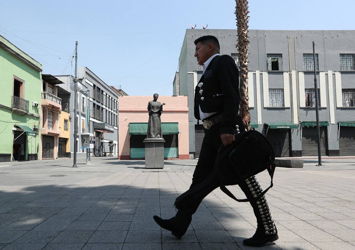 Un Mariachi camina hoy frente a la estatua de "Lola Beltrán", en la Plaza Garibaldi, en la Ciudad de México (México). EFE/ Mario Guzmán