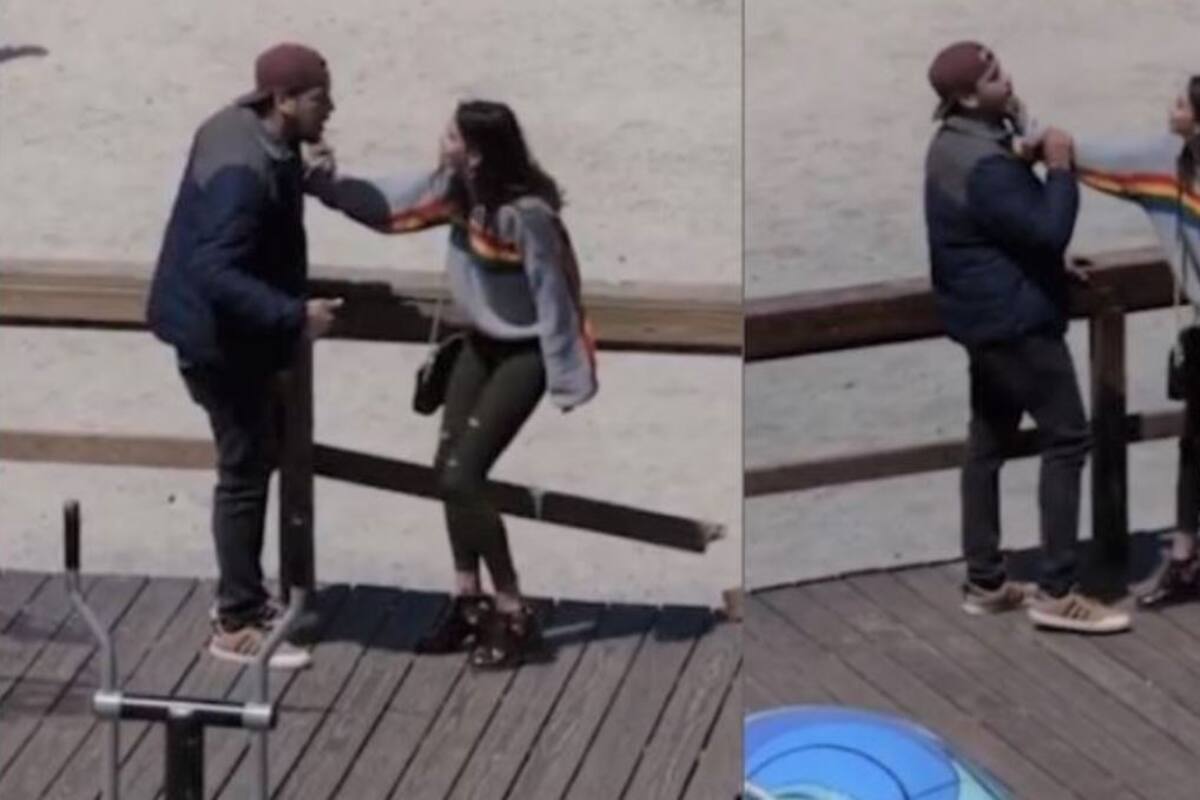 Pareja discute agresivamente en playa; testigos actúan indiferentes