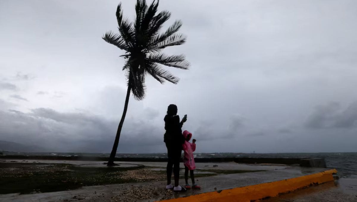 A woman and a child stand along the Kingston waterfront as Hurricane Melissa approaches, in Kingston, Jamaica. REUTERS Octavio Jones.