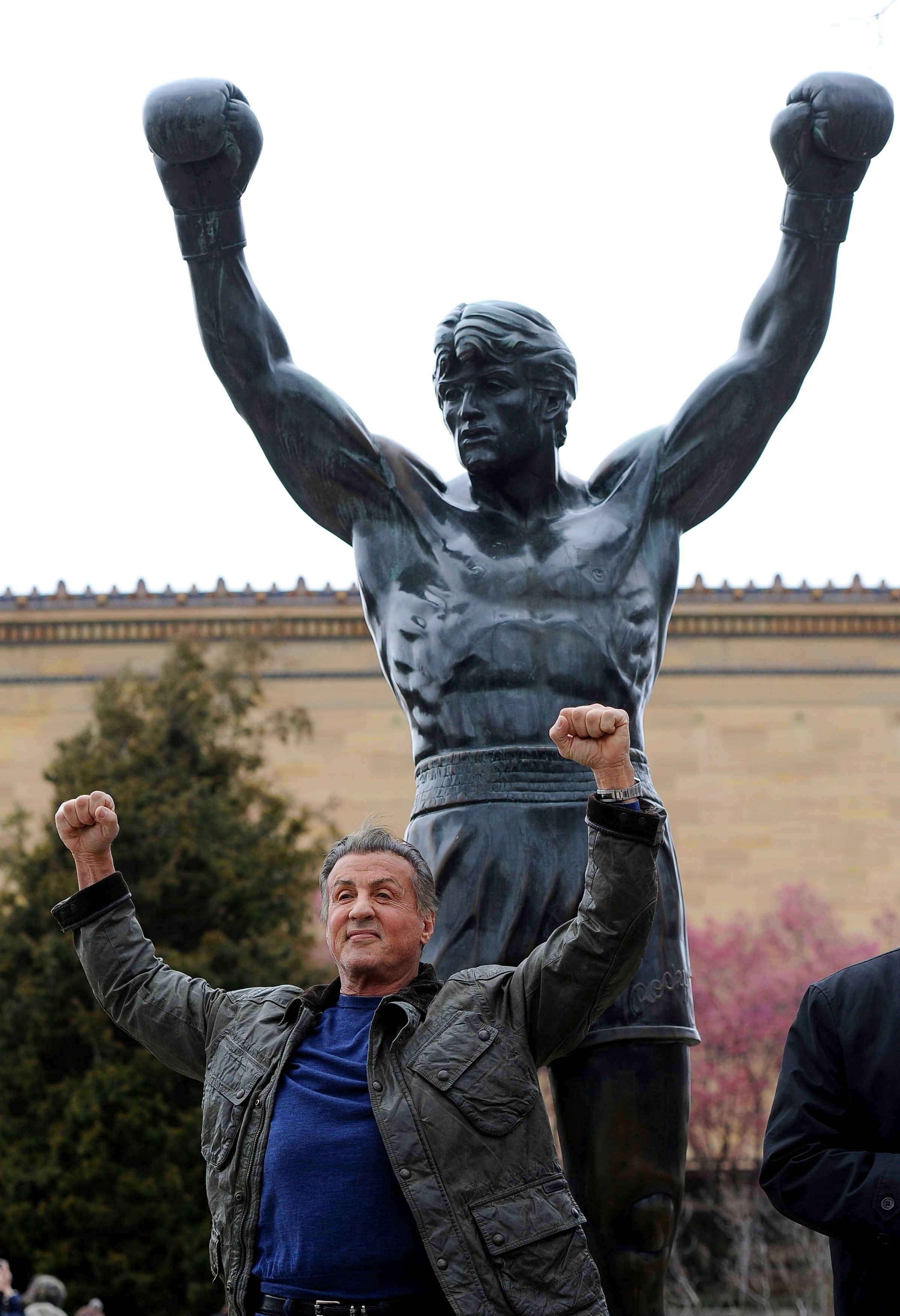 Sylvester Stallone poses in front of the Rocky statue at the Philadelphia Art Museum at a photo op to promote "Creed II" in Philadelphia on Friday, April 6, 2018. The film, part of the "Rocky" film franchise, will be released later this year. (AP Photo/Michael Perez)
