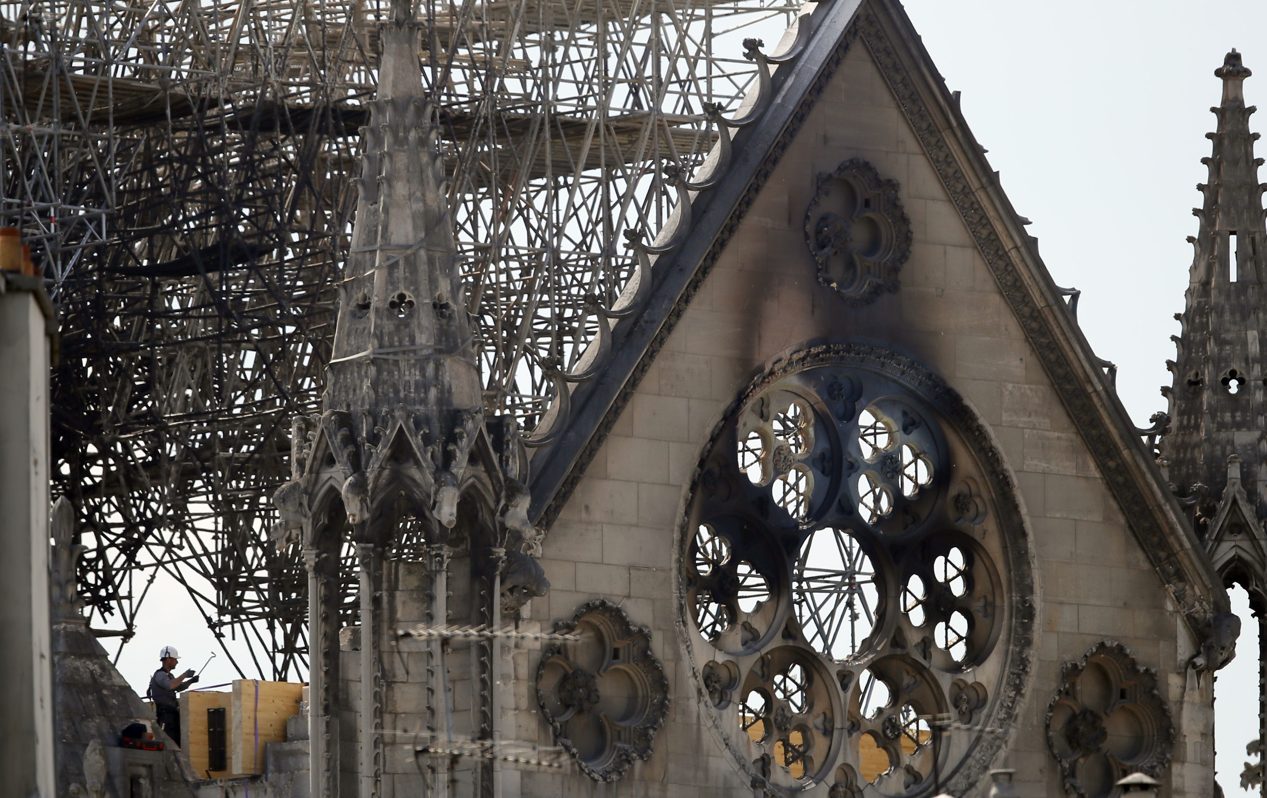A worker checks on a wooden support structure placed on the Notre Dame Cathedral in Paris, Wednesday, April 17, 2019. Nearly $1 billion has already poured in from ordinary worshippers and high-powered magnates around the world to restore Notre Dame Cathedral in Paris after a massive fire. (AP Photo/Francois Mori)